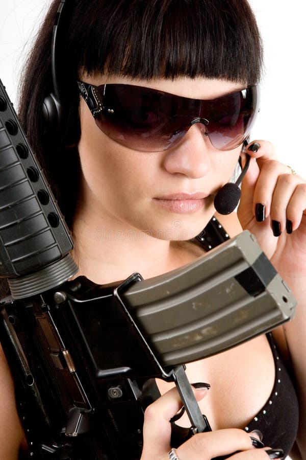 Sexi girl in black dress with gun and headphones. Sexi girl in black dress with gun and headphones.
