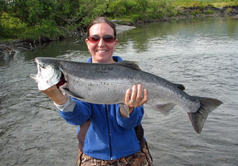 Girl holding silver salmon in Alaska. Girl holding silver salmon in Alaska