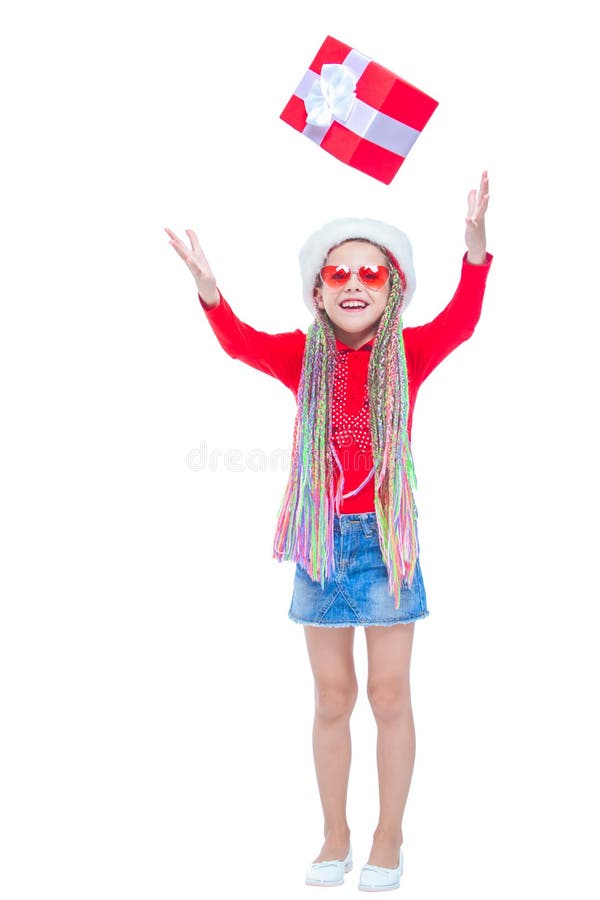 Portrait of little cute girl holding box of Christmas present, Small girl hug her gift with happy and fun expression isolated on white background. Holiday gift. Portrait of little cute girl holding box of Christmas present, Small girl hug her gift with happy and fun expression isolated on white background. Holiday gift.