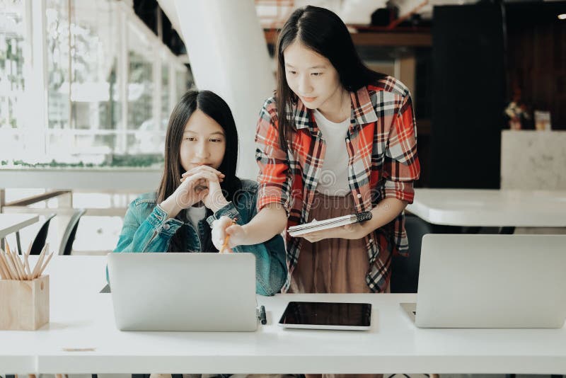 Meisjestiener die met computer bestuderen de student die van de universiteitsmiddelbare school nota nemen royalty-vrije stock fotografie Meisjestiener die met computer bestuderen de student die van de universiteitsmiddelbare school nota nemen royalty-vrije stock fotografie