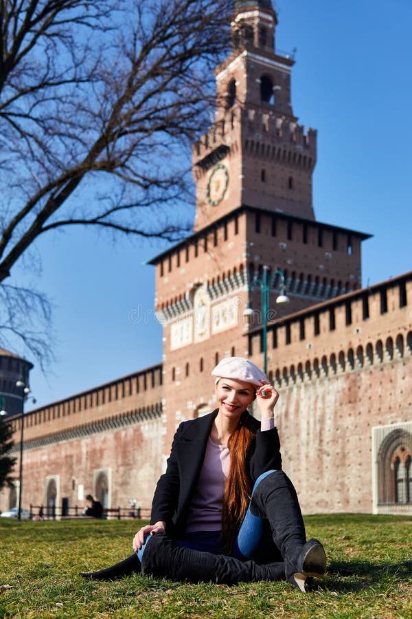 Meisjeszitting voor de glimlach van Castelo Sforzesco voor een portret royalty-vrije stock afbeelding Meisjeszitting voor de glimlach van Castelo Sforzesco voor een portret royalty-vrije stock afbeelding