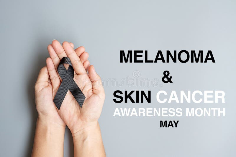 Melanoma and skin cancer, Vaccine injury awareness month and rest in peace concepts. Man holding black Ribbon on grey background