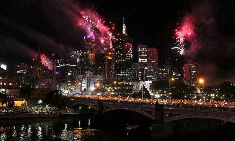 New year eve fireworks in Melbourne with view of skyline and crowded princes bridge over yarra river. New year eve fireworks in Melbourne with view of skyline and crowded princes bridge over yarra river.
