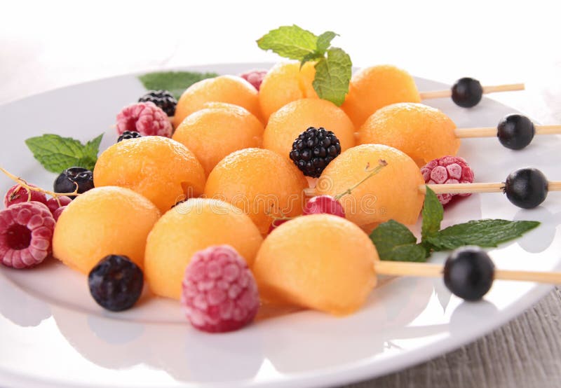 Melon and berries fruits stock image. Image of skewer 26280245