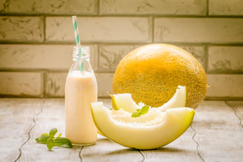 Melon smoothie in a glass bottle