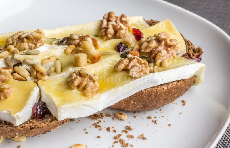 Melted Brie with Honey and Walnuts on Dark Bread Stock Photo Image of