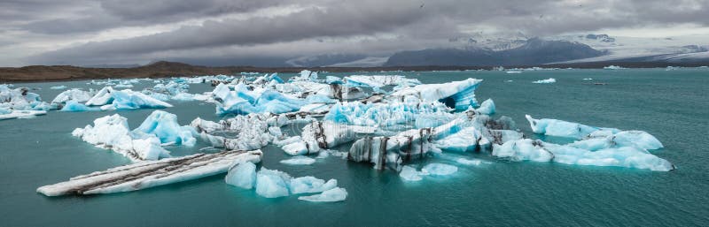 Melting icebergs at glacier lake Jokulsarlon Southeastern Iceland Scandinavia panorama royalty free stock photography Melting icebergs at glacier lake Jokulsarlon Southeastern Iceland Scandinavia panorama royalty free stock photography