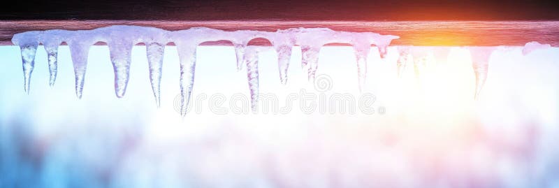 Melting icicles dangle dangerously in early spring light, hinting at the change of seasons and the warmth to come royalty free stock photos