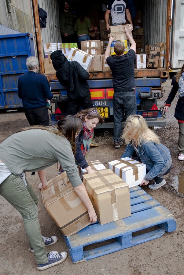 Members and volunteers from BookCycle UK load a container