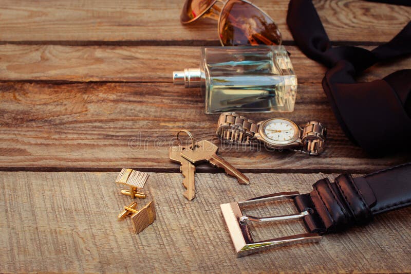 Men accessories sunglasses, bag, money, wrist watch, cufflinks, comb, strap, keys, perfume on the old wood background. Toned image. Button clasp stock images, royalty-free photos and pictures