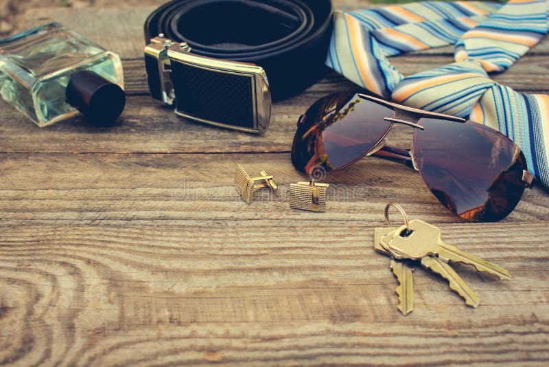Men accessories: sunglasses, tie, cufflinks, strap, keys, perfume on the old wood background. Toned image. Button clasp stock images, royalty-free photos and pictures