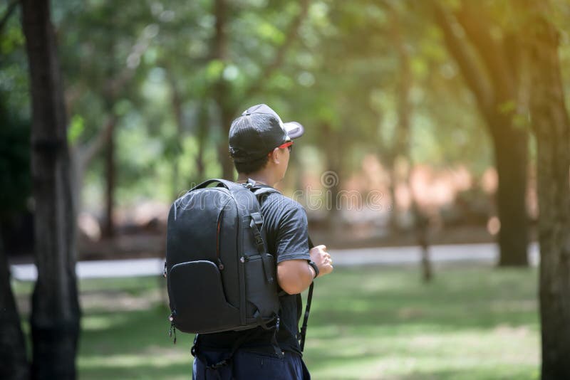 Men asian with bright backpack of the tourist traveler on nature stock photo