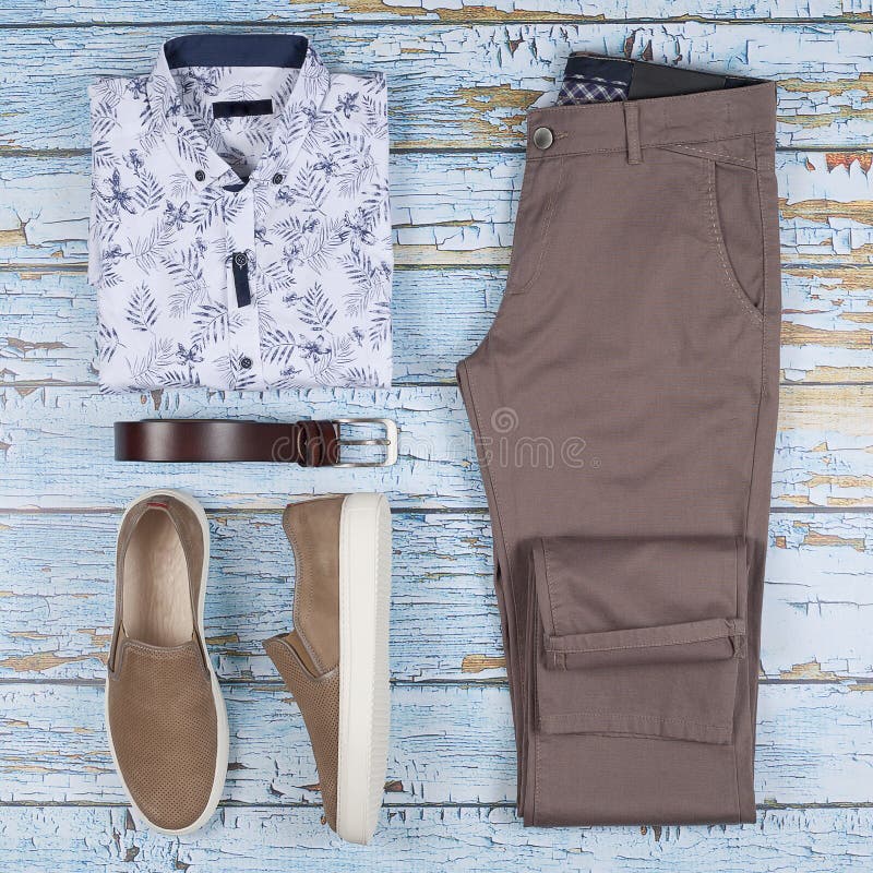 Men casual outfit. Men`s shoes, clothing and accessories on wooden background - jeans, shirt, sneakers, belt. Top view. Flat lay stock photography Men casual outfit. Men`s shoes, clothing and accessories on wooden background - jeans, shirt, sneakers, belt. Top view. Flat lay stock photography