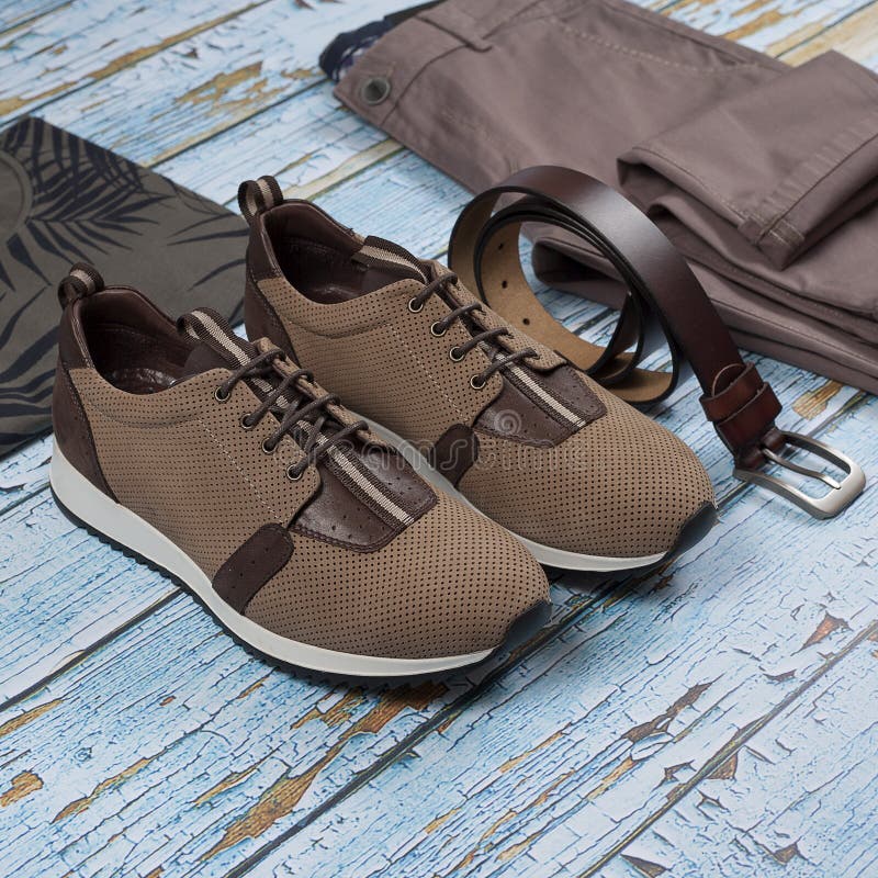 Men casual outfit. Men`s shoes, clothing and accessories on wooden background - jeans, shirt, sneakers, belt. Top view. Flat lay stock photo Men casual outfit. Men`s shoes, clothing and accessories on wooden background - jeans, shirt, sneakers, belt. Top view. Flat lay stock photo