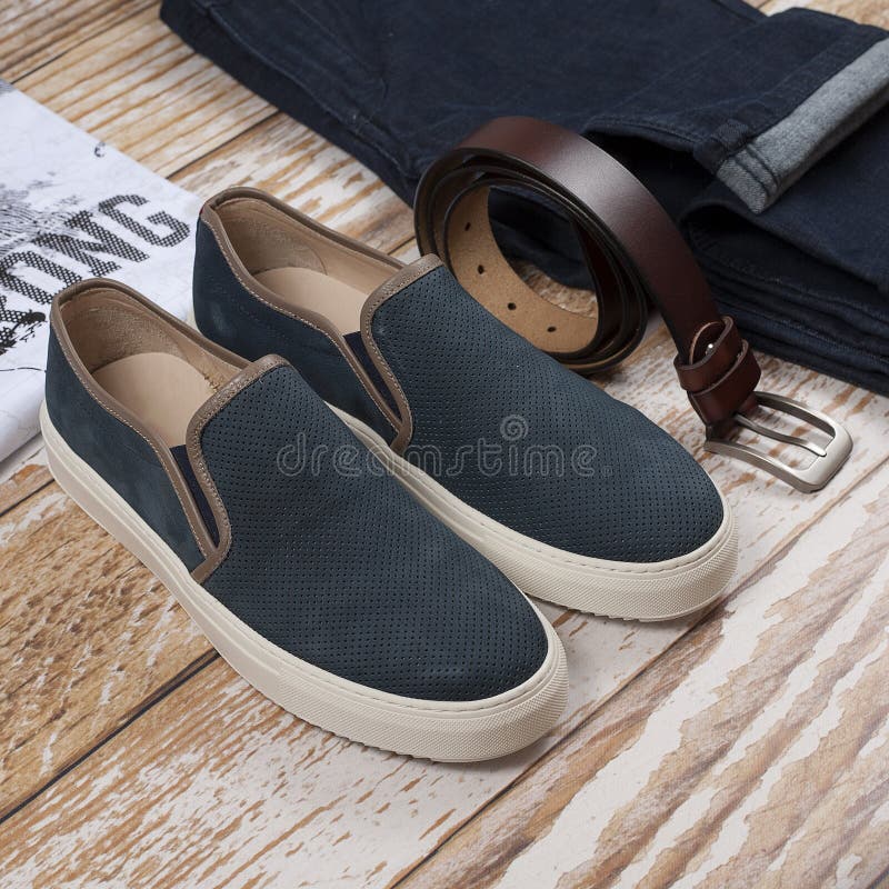 Men casual outfit. Men`s shoes, clothing and accessories on wooden background - jeans, shirt, sneakers, belt. Top view. Flat lay royalty free stock images Men casual outfit. Men`s shoes, clothing and accessories on wooden background - jeans, shirt, sneakers, belt. Top view. Flat lay royalty free stock images