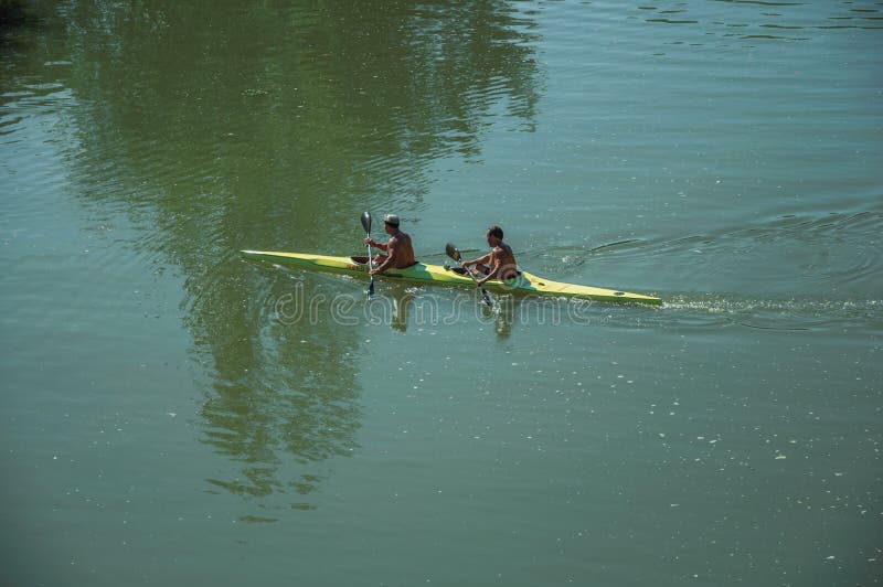 Men on kayak paddling on the Guadiana River at Merida stock image Men on kayak paddling on the Guadiana River at Merida stock image