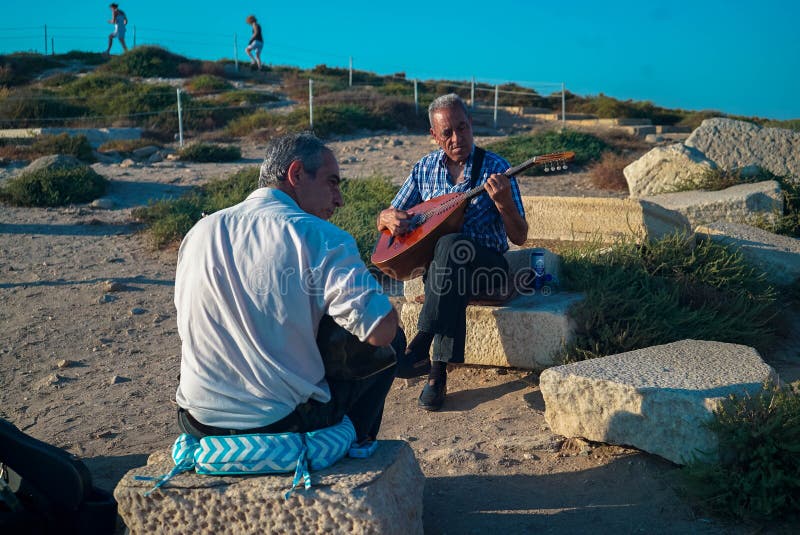 2 men playing the bouzouki on the ancient mycenaean ruin on Naxos
