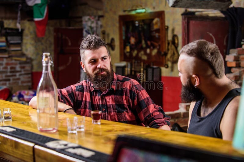 Men relaxing at bar. Strong alcohol drinks. Friday relaxation in bar. Friends relaxing in bar or pub. Interesting royalty free stock photography Men relaxing at bar. Strong alcohol drinks. Friday relaxation in bar. Friends relaxing in bar or pub. Interesting royalty free stock photography