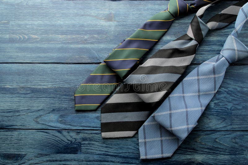 Men`s Accessories.men`s style. various ties on blue wooden background. flat lay. with space for text royalty free stock photography Men`s Accessories.men`s style. various ties on blue wooden background. flat lay. with space for text royalty free stock photography
