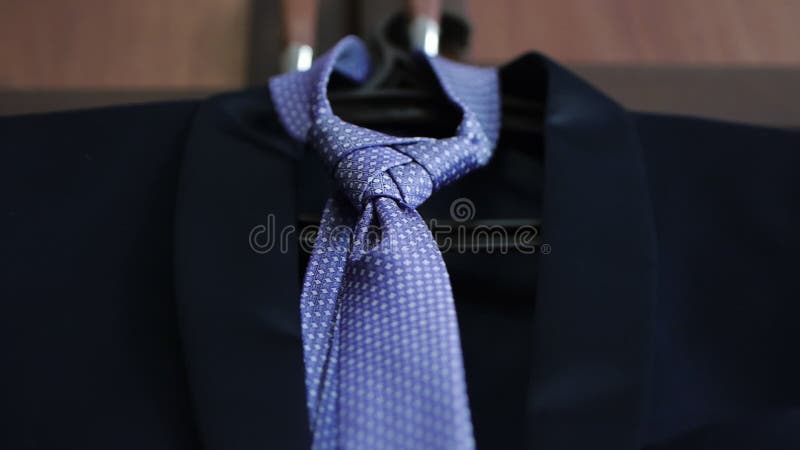 Men's accessories tie and jacket hanging on a hanger