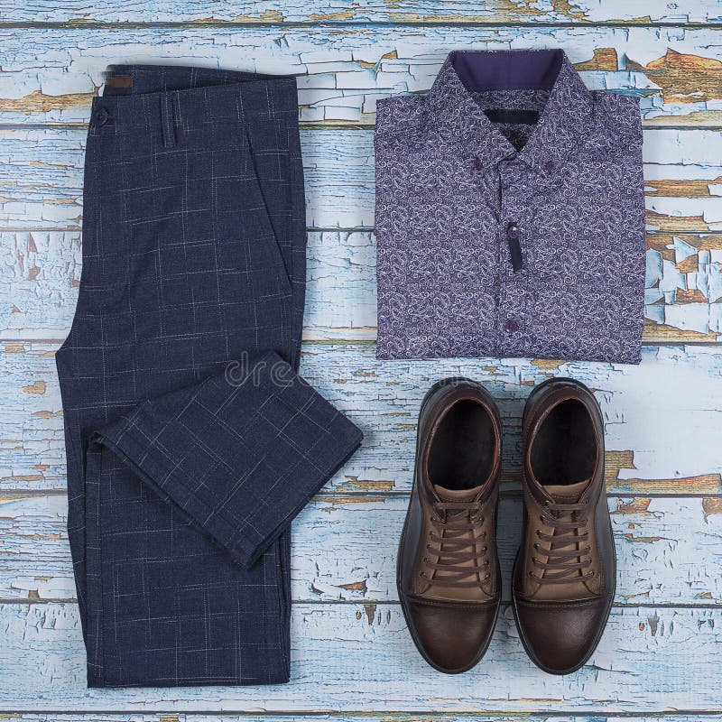 Men`s casual outfits for men clothing set with shoes, trousers, shirt on wooden background, Top view stock images Men`s casual outfits for men clothing set with shoes, trousers, shirt on wooden background, Top view stock images