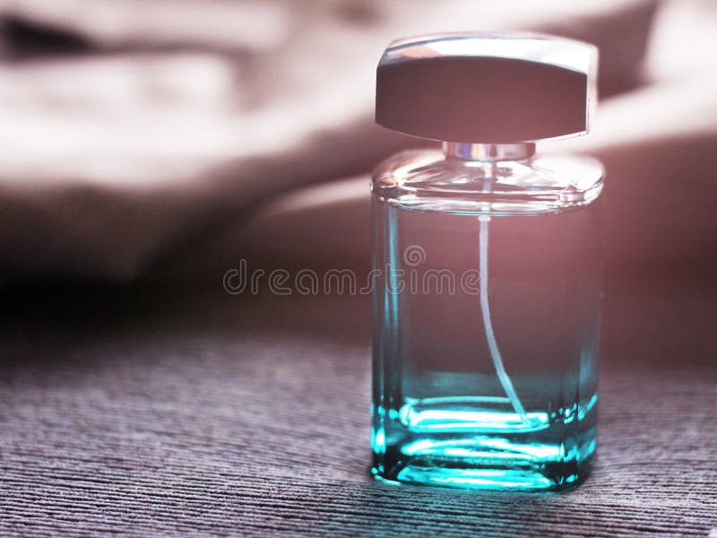 Men`s Green Perfume in Beautiful Bottle on Blue Textile Stock Image