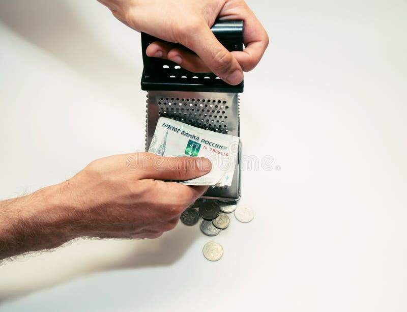 Men`s Hands Rub a Banknote on a Grater, and Coins Lie Below Stock Image