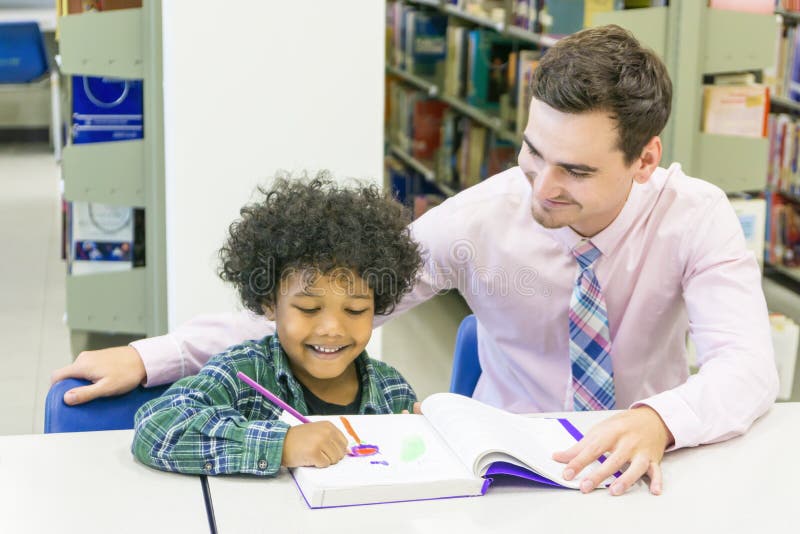 man teacher and kid student learn with book at bookshelf background