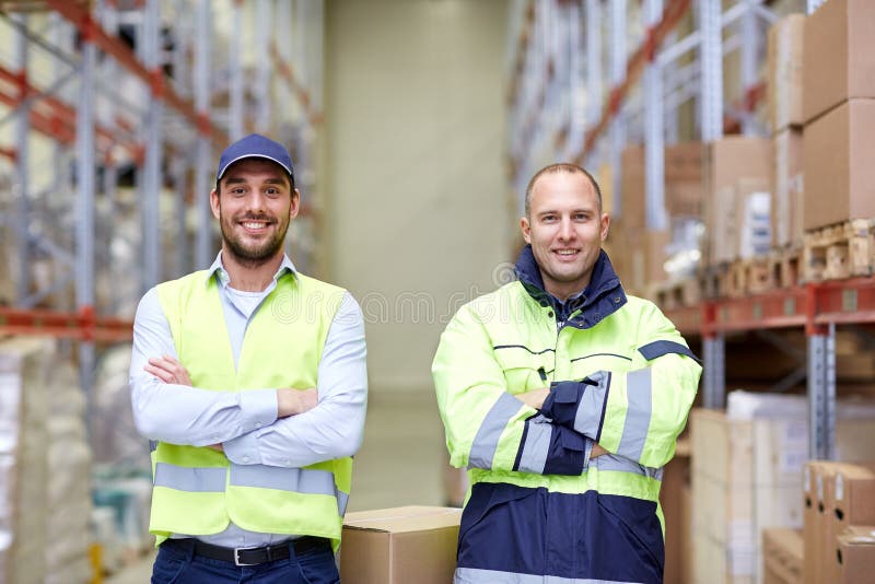 Men In Uniform With Boxes At Warehouse Stock Photo - Image of indoors