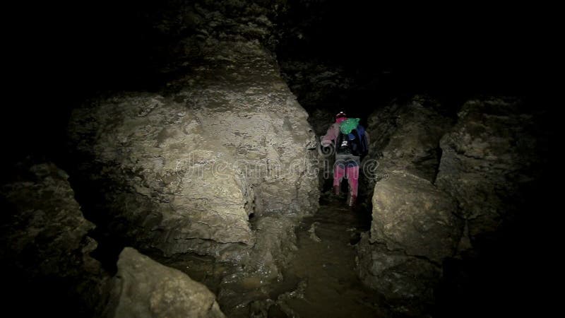 Men Walks in the Cave. Speleolog in the Cave