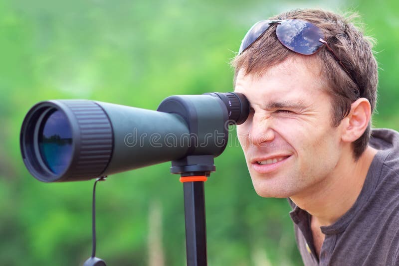 Men who is watching in spotting scope. stock photography Men who is watching in spotting scope. stock photography