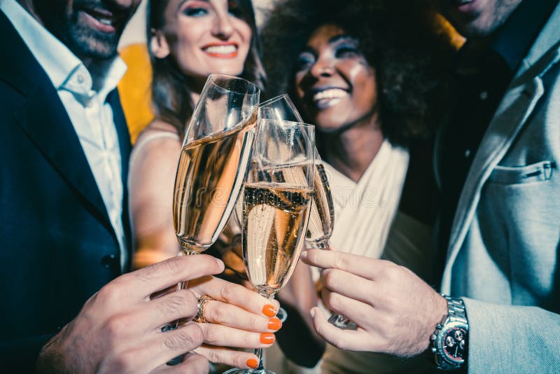 Men and women celebrating party while clinking glasses with sparkling wine stock images Men and women celebrating party while clinking glasses with sparkling wine stock images