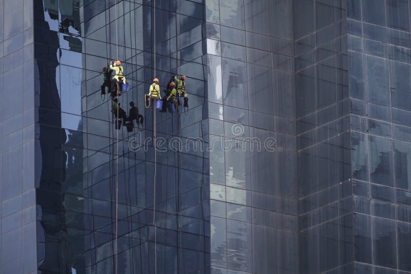 Men at work cleaning the facade of a skyscaper