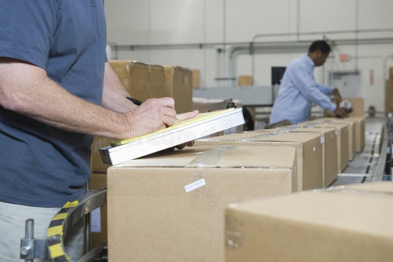 Men Working In Distribution Warehouse stock image Men Working In Distribution Warehouse stock image