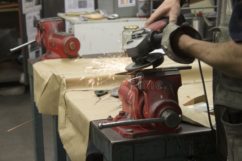 Men working the iron in a work table stock photo