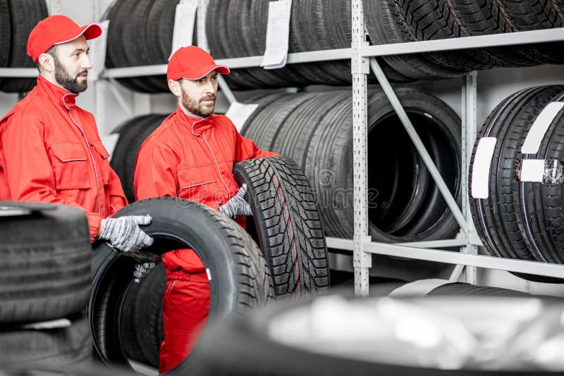 Men Working in the Warehouse with Tires Stock Image Image of carrying
