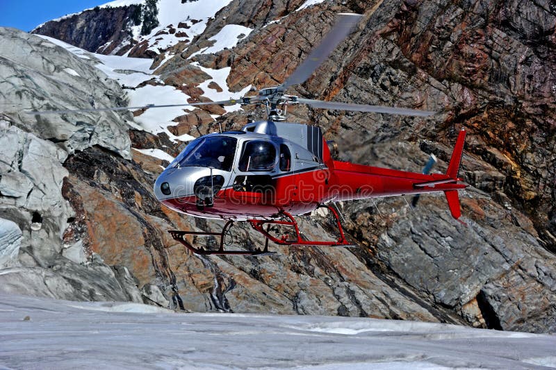 Mendenhall Glacier. Helicopter is landing on Mendenhall Glacier located in Mendenhall Valley, about 12 miles from downtown Juneau in the southeast area of the U royalty free stock photography Mendenhall Glacier. Helicopter is landing on Mendenhall Glacier located in Mendenhall Valley, about 12 miles from downtown Juneau in the southeast area of the U royalty free stock photography