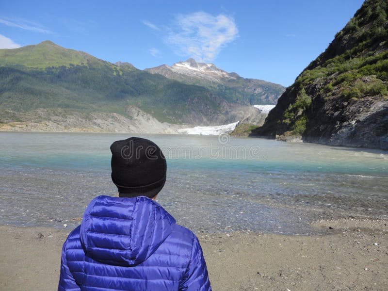 Mendenhall Glacier Juneau Alaska. Mendenhall Glacier flowing into Mendenhall Lake in between mountains with Nugget falls. Perfect. Tourist location. Girl royalty free stock photos Mendenhall Glacier Juneau Alaska. Mendenhall Glacier flowing into Mendenhall Lake in between mountains with Nugget falls. Perfect. Tourist location. Girl royalty free stock photos