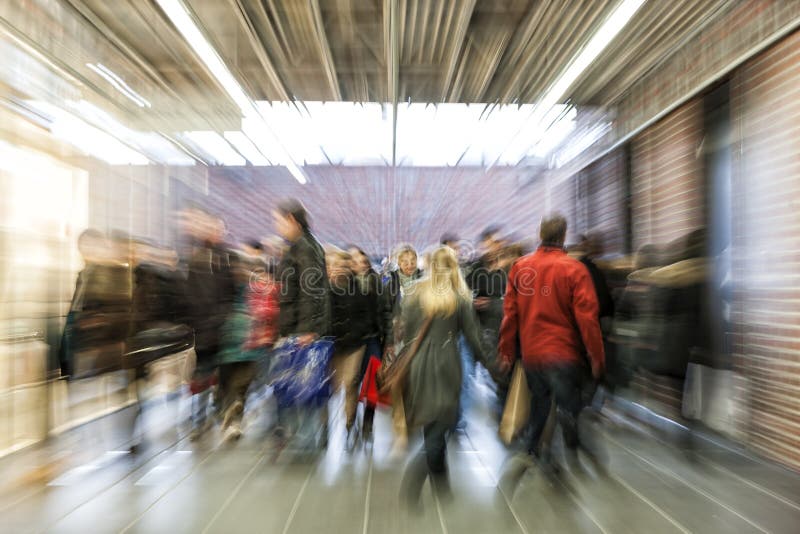 Crowd of people rushing through corridor, zoom effect, motion blur, cross balance. Crowd of people rushing through corridor, zoom effect, motion blur, cross balance