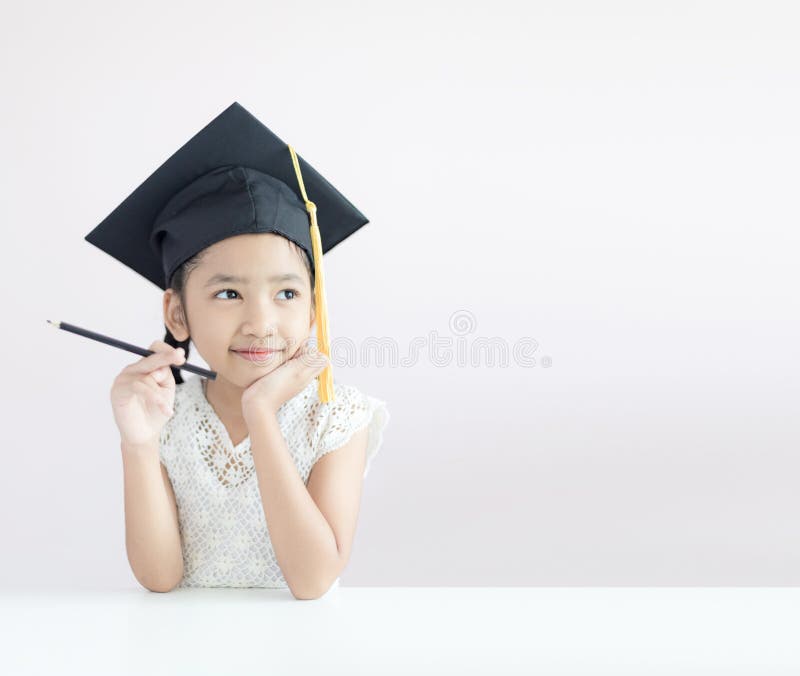 Portrait little Asian girl is wearing graduate hat holding pencil sitting thinking something and smile with happiness select focus shallow depth of field with copy space for education concept, child, kid, cute, happy, white, childhood, beautiful, young, female, person, people, cheerful, pretty, chinese, face, japanese, fun, joy, korean, beauty, background, student, expression, thai, lovely, studio, lifestyle, adorable, daughter, red, family, human, small, youth, hair, school, woman, preschool, caucasian. Portrait little Asian girl is wearing graduate hat holding pencil sitting thinking something and smile with happiness select focus shallow depth of field with copy space for education concept, child, kid, cute, happy, white, childhood, beautiful, young, female, person, people, cheerful, pretty, chinese, face, japanese, fun, joy, korean, beauty, background, student, expression, thai, lovely, studio, lifestyle, adorable, daughter, red, family, human, small, youth, hair, school, woman, preschool, caucasian