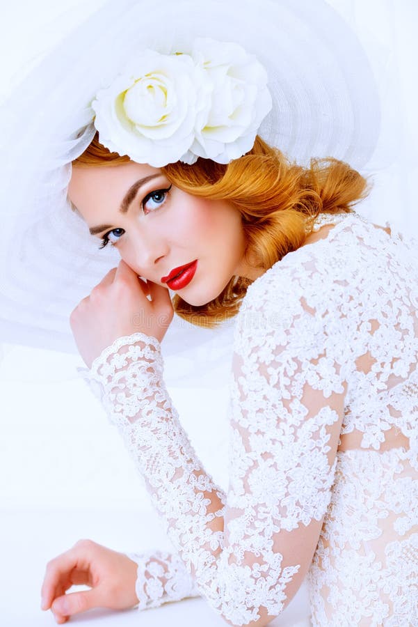 Portrait of a beautiful tender bride woman wearing elegant lace dress and broad-brimmed hat. Wedding. Beauty, fashion concept. Portrait of a beautiful tender bride woman wearing elegant lace dress and broad-brimmed hat. Wedding. Beauty, fashion concept.