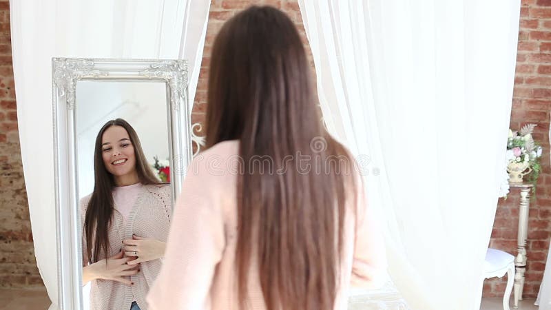 A Menina Bonita Olha Em Um Espelho Em Um Banheiro Foto de Stock - Imagem de  cara, adulto: 13967092