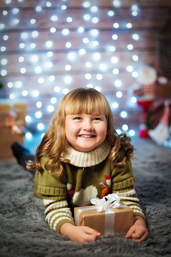 Menina bonito bonita no fundo do Natal com presente imagem de stock Menina bonito bonita no fundo do Natal com presente imagem de stock