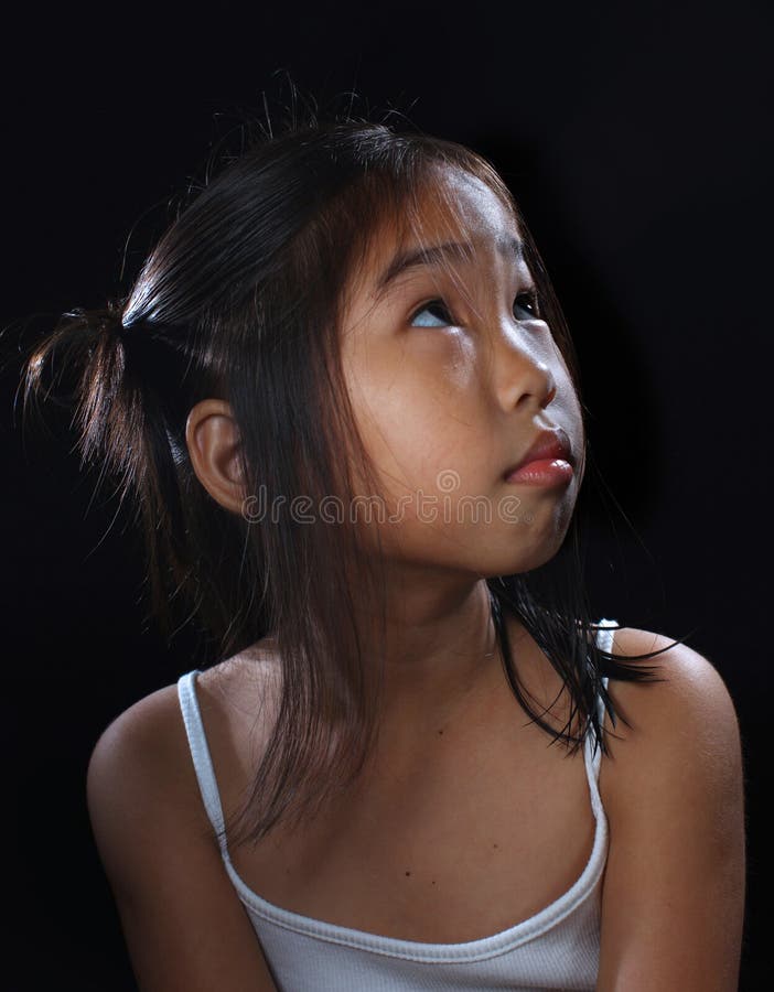 Cute little asia girl in mood lighting with black background. Cute little asia girl in mood lighting with black background