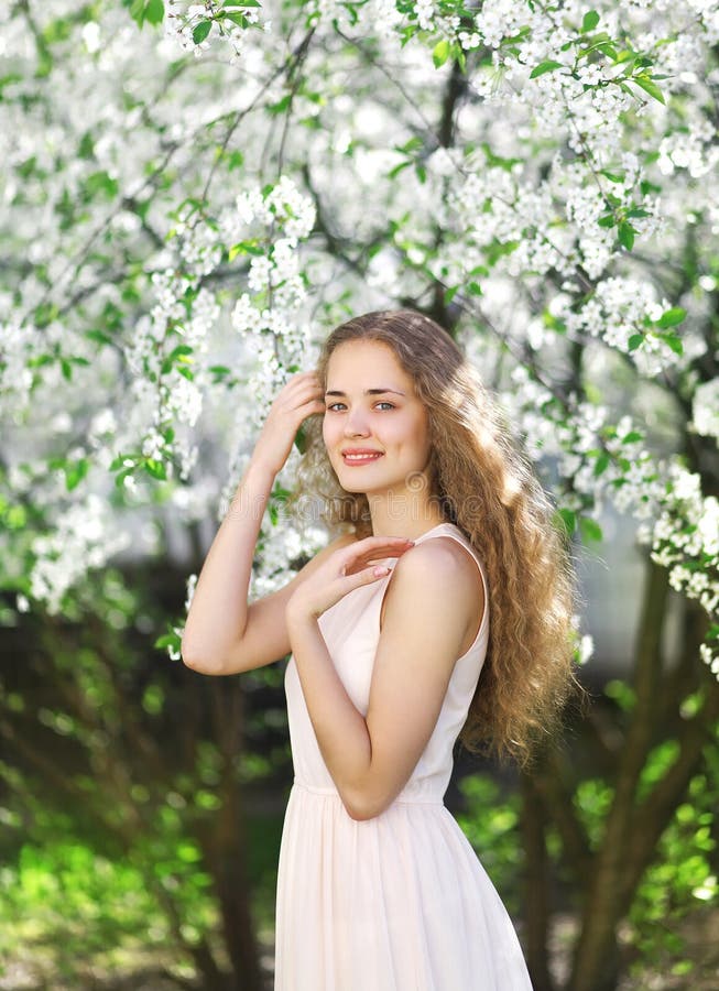 Cute girl smiling in the blooming garden, floral, spring concept. Cute girl smiling in the blooming garden, floral, spring concept