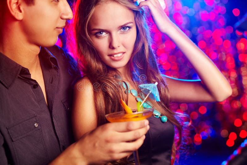 Image of pretty girl with her boyfriend in the night club. Image of pretty girl with her boyfriend in the night club