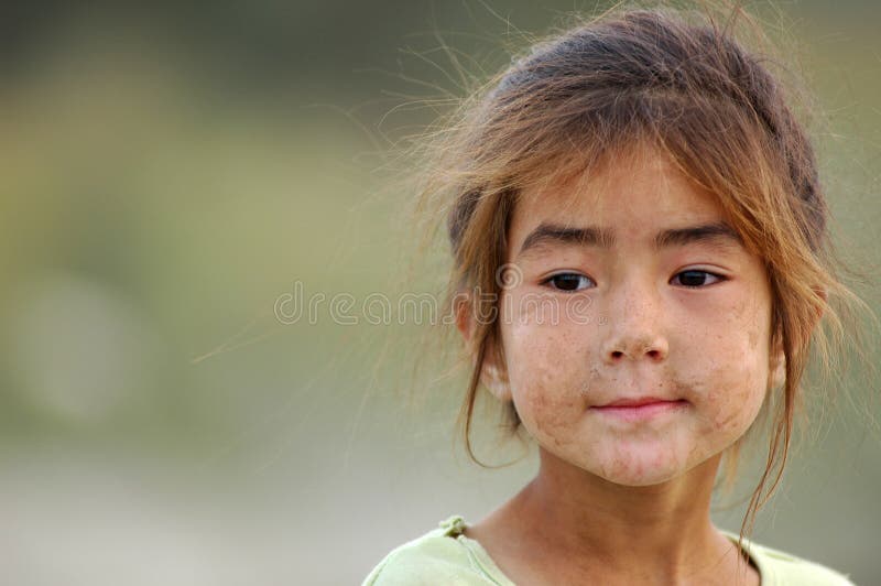 Portrait of a poor Uyghur girl with dirty face,Xinjiang,China. Used for news and articles about the local minority people and poor life in Xinjiang. Portrait of a poor Uyghur girl with dirty face,Xinjiang,China. Used for news and articles about the local minority people and poor life in Xinjiang.