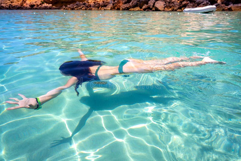 Ibiza bikini girl swimming clear water beach of Balearic Islands. Ibiza bikini girl swimming clear water beach of Balearic Islands