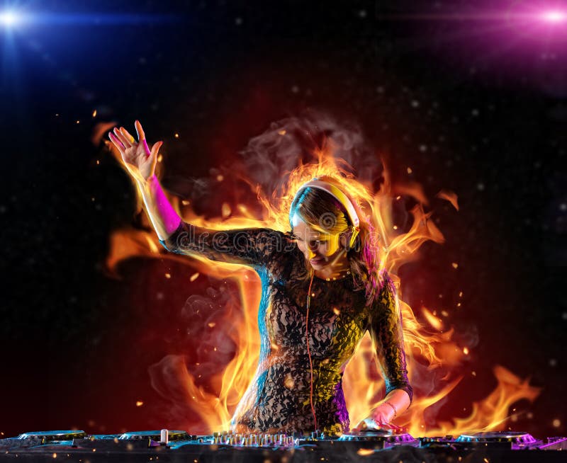 Disc jockey brunette girl mixing electronic music with fire flames around. Disc jockey brunette girl mixing electronic music with fire flames around