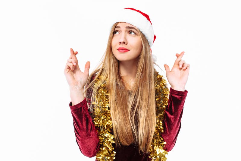 Menina doce bonita no chapéu de Santa Claus e em um vestido, p fotografia de stock royalty free Menina doce bonita no chapéu de Santa Claus e em um vestido, p fotografia de stock royalty free
